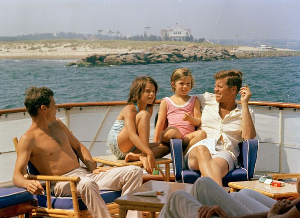 JFK spending time on the bow of Honey Fitz with friends and family.