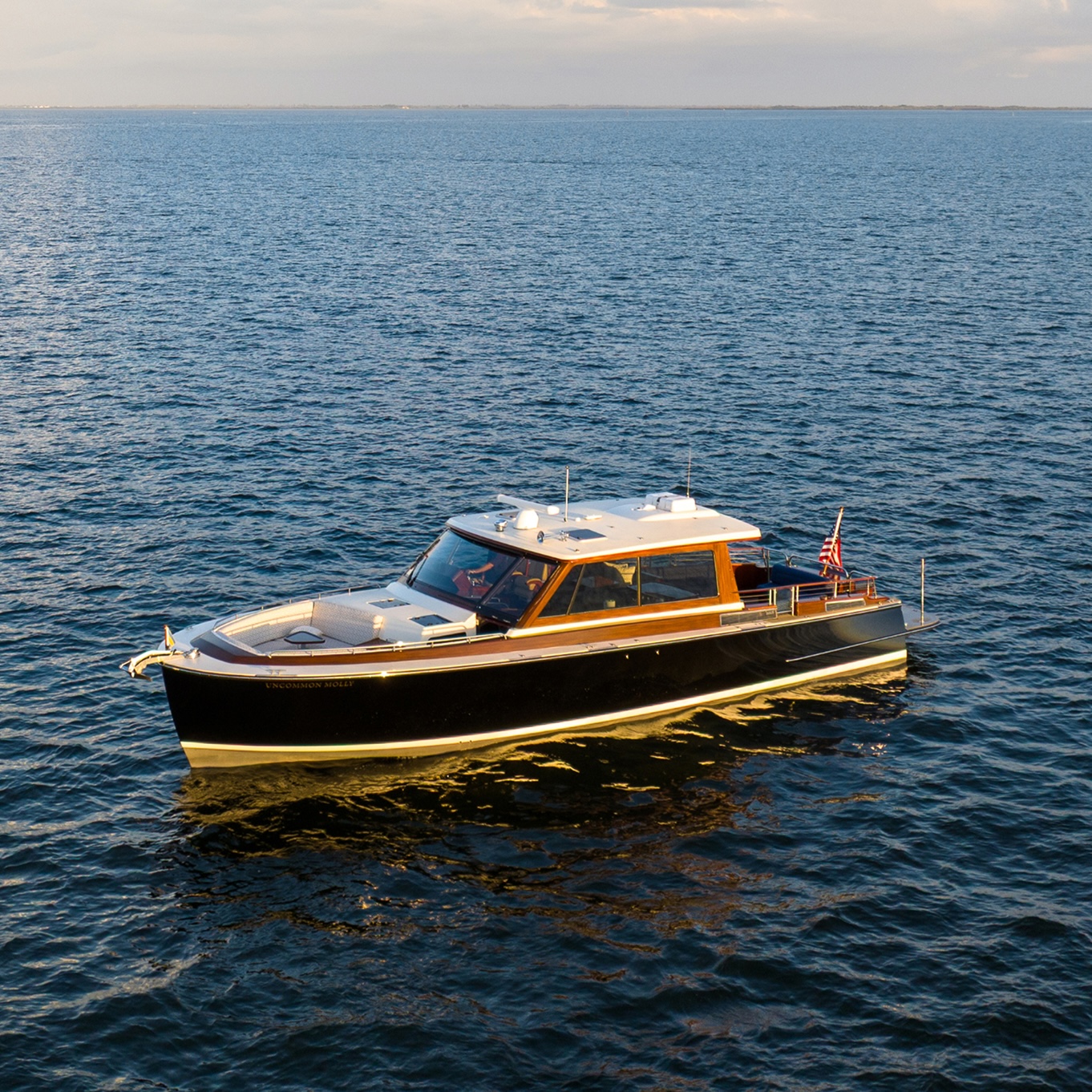 B&G Daychaser in the navy ocean, with the sun shining along the port side.