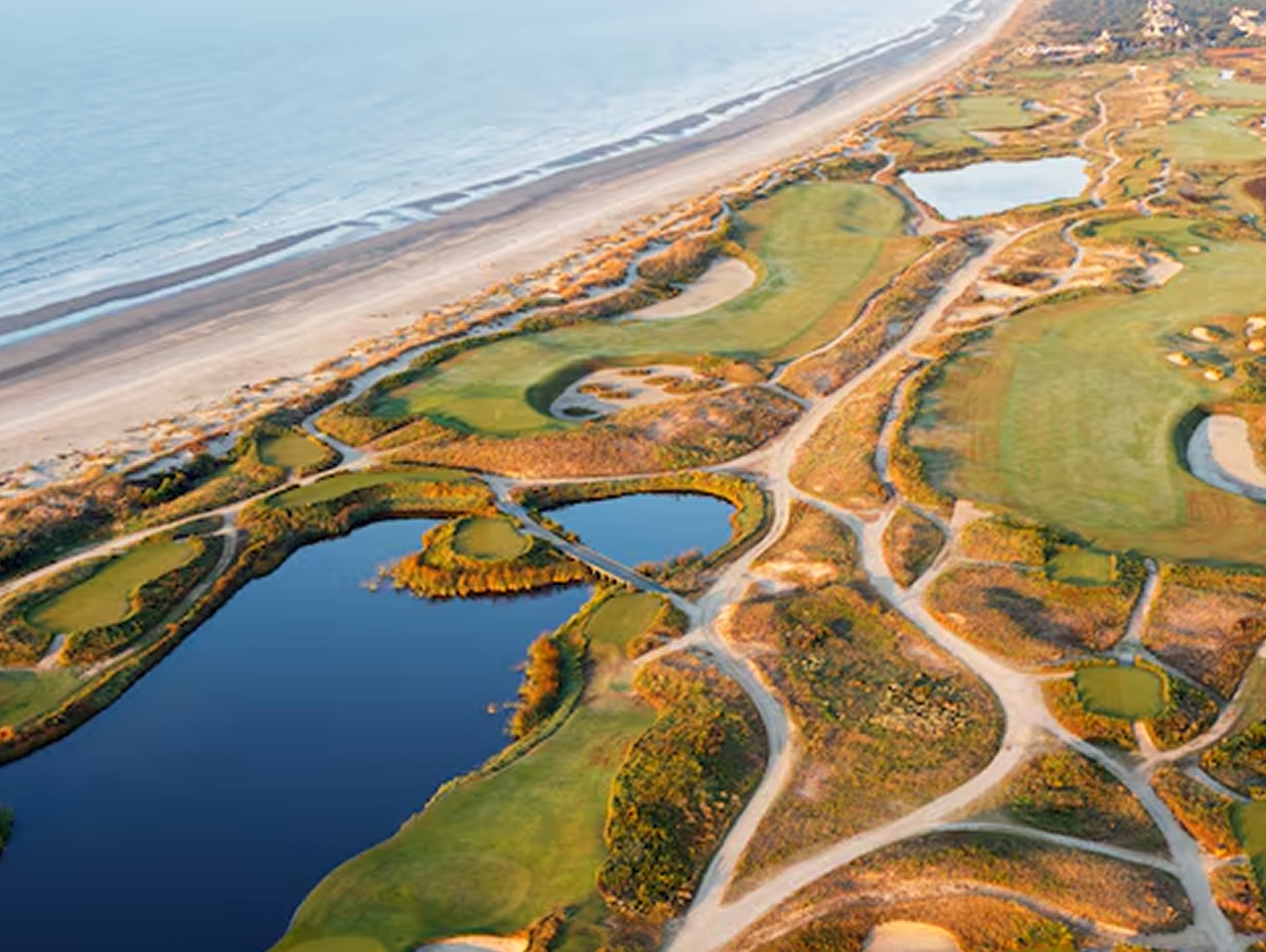 Golfers playing on Kiawah Island's coastal course with ocean views