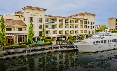 Delamar Greenwich Harbor hotel and marina on the waterfront with docked yachts