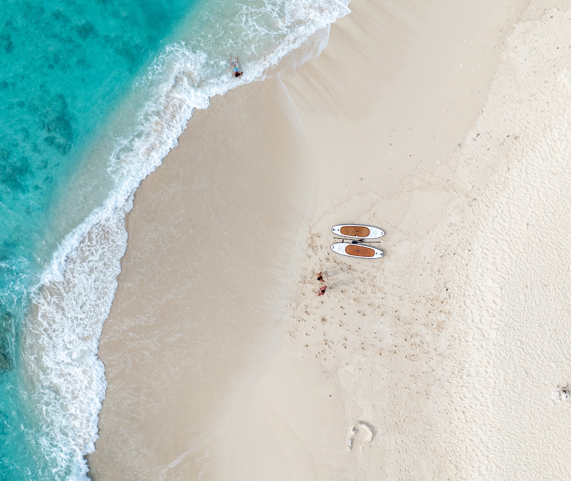 Paddleboards resting on the beach