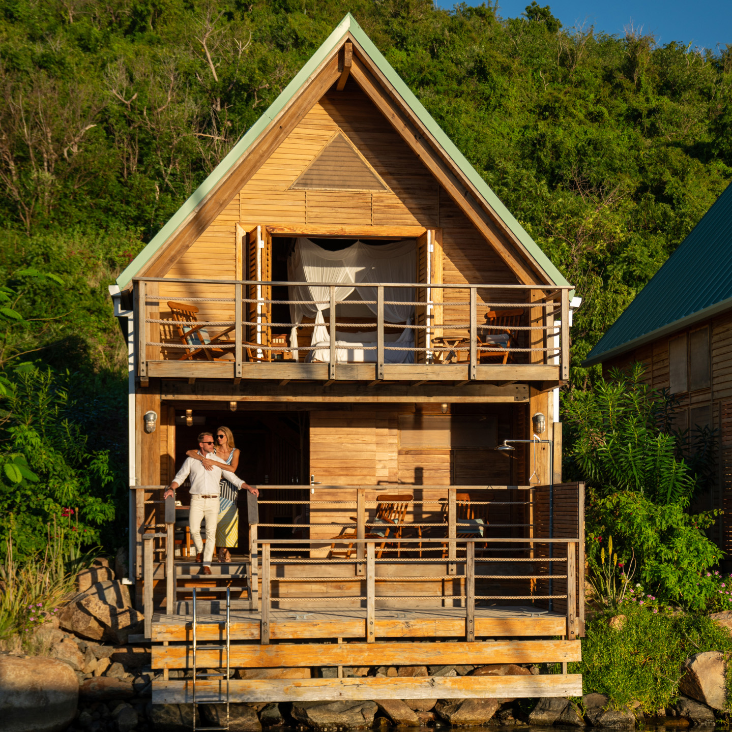 Couple enjoying the sunset on the porch of a beach house