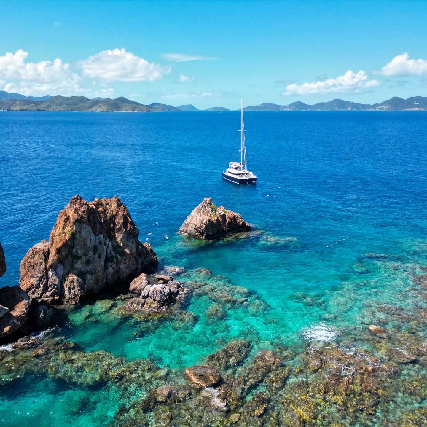 Andromeda anchored off a rocky coastline