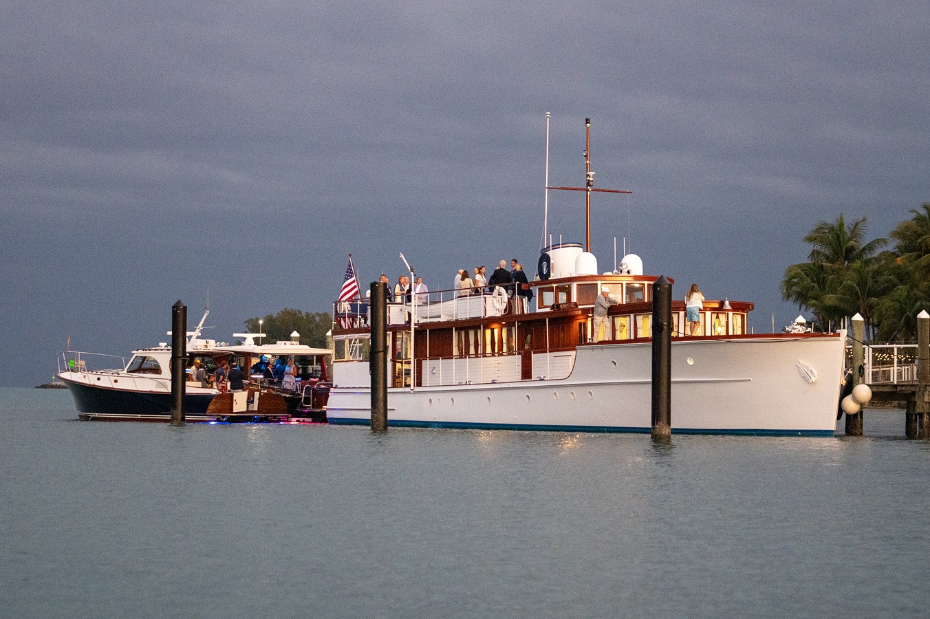 B&G party aboard the legendary Honey Fitz, with a dark sky in the background.
