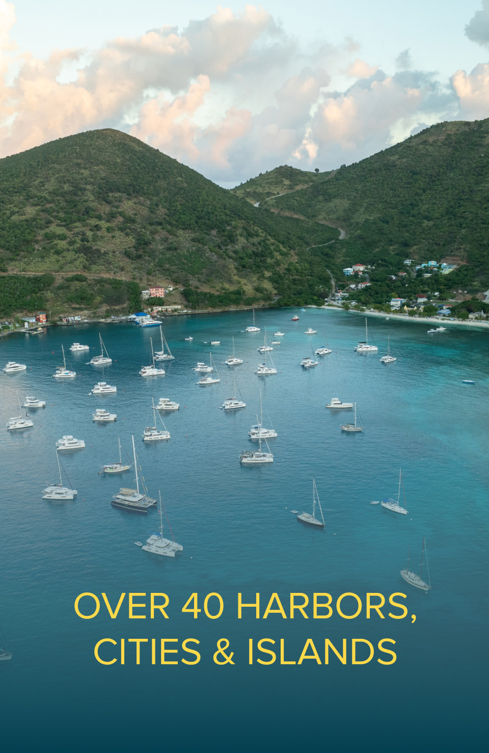 Beautiful cove with several sailboats and catamarans moored.