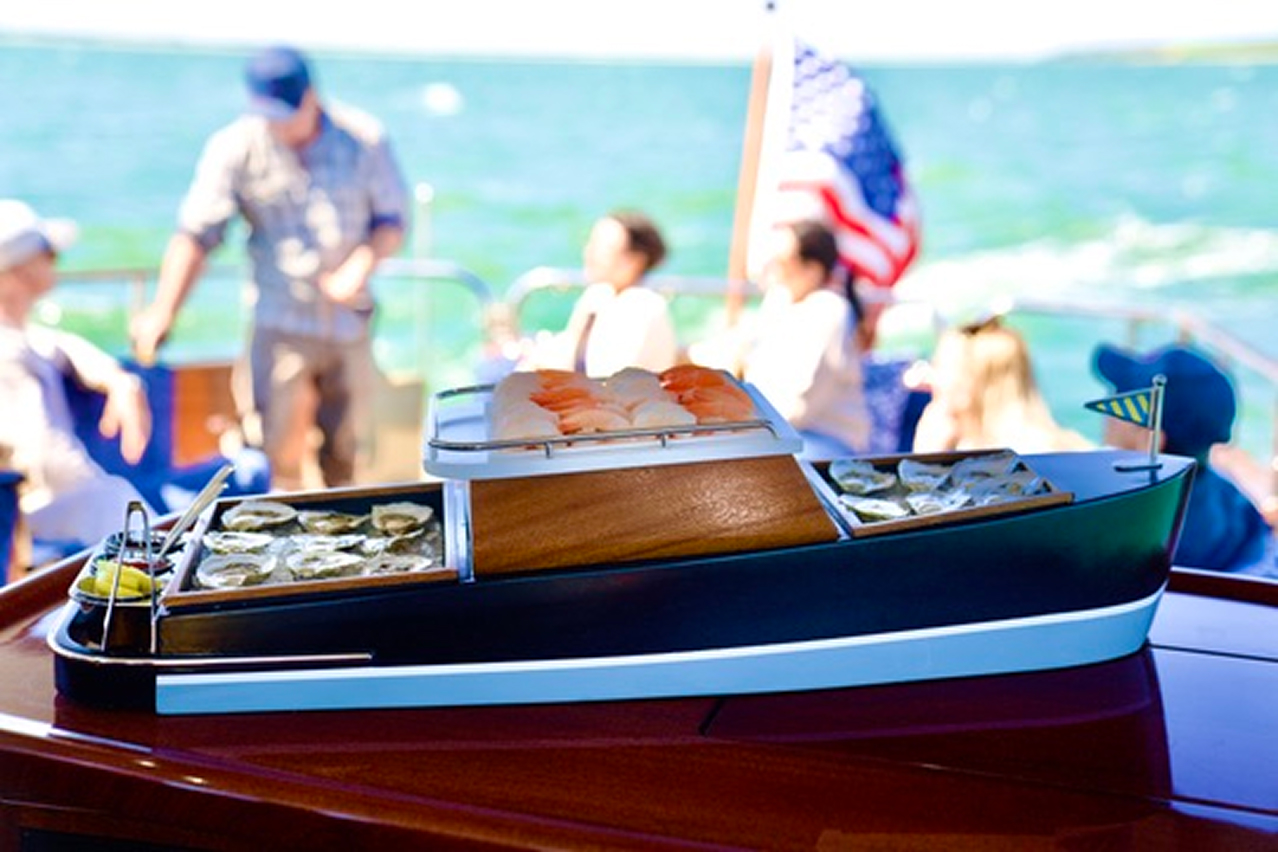 A close up of a mini daychaser 48' yacht with an oyster platter and sushi.