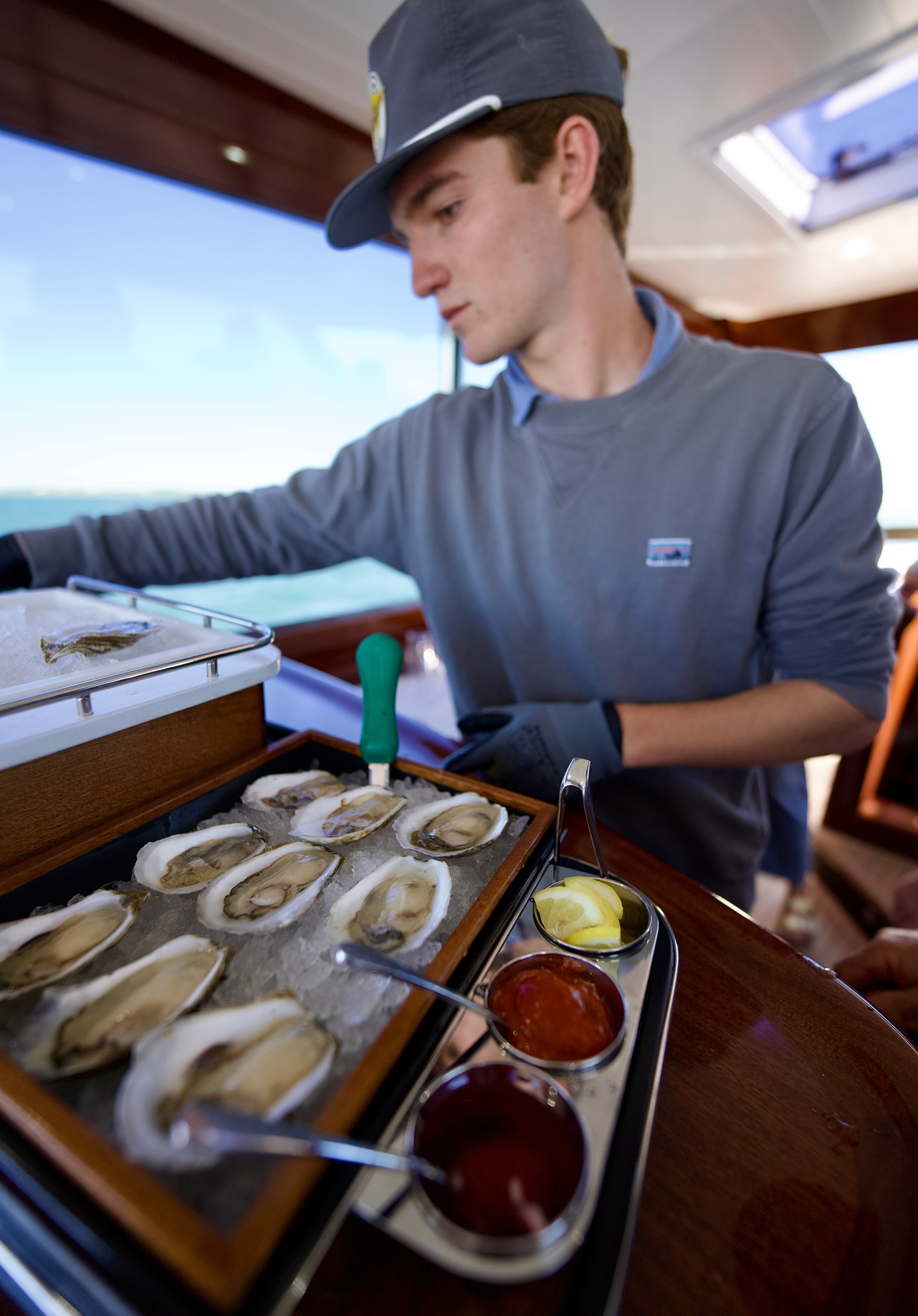 Fifth Bend Oysters shucker preparing a platter of oysters.