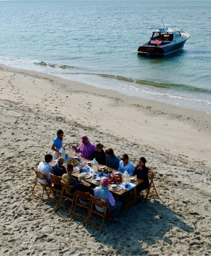 Guests enjoying the Nantucket lobster boil aboard a Barton & Gray yacht