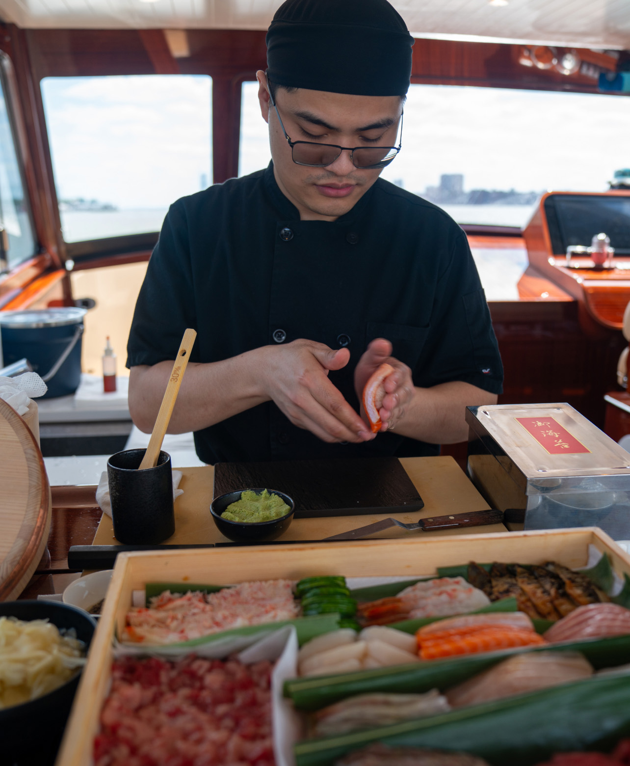 Omakase chef preparing sushi on a Barton & Gray yacht