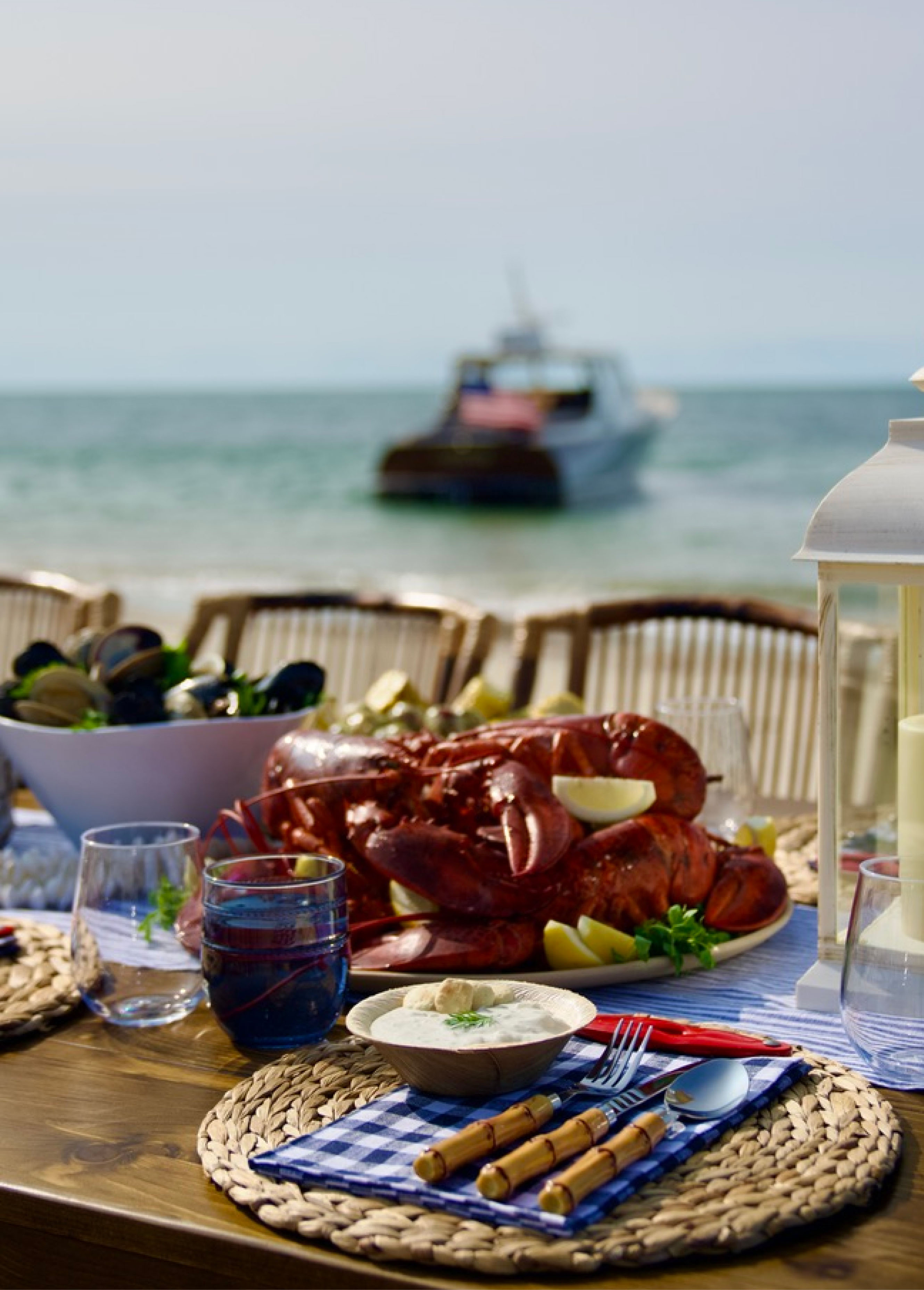 Gourmet seafood platter featuring lobster, shrimp, and oysters on a bed of ice, served aboard a luxury yacht by Barton & Gray Mariners Club.