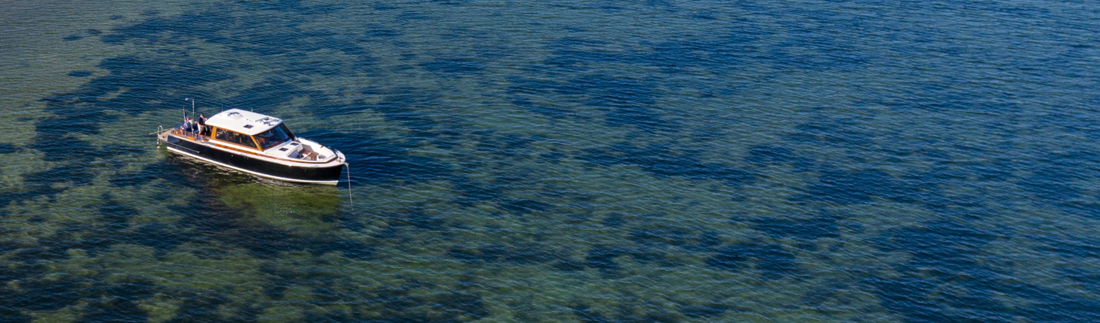 Daychaser moored over crystal clear water.